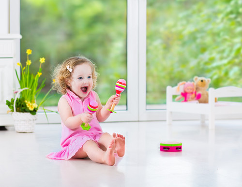 Funnytoddlergirlplayingtambourineinsunnywhiteroom.jpg